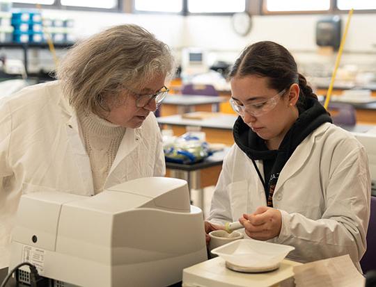 two women conducting experiment in a lab